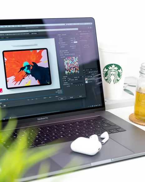 A graphic design using Photoshop on a laptop 