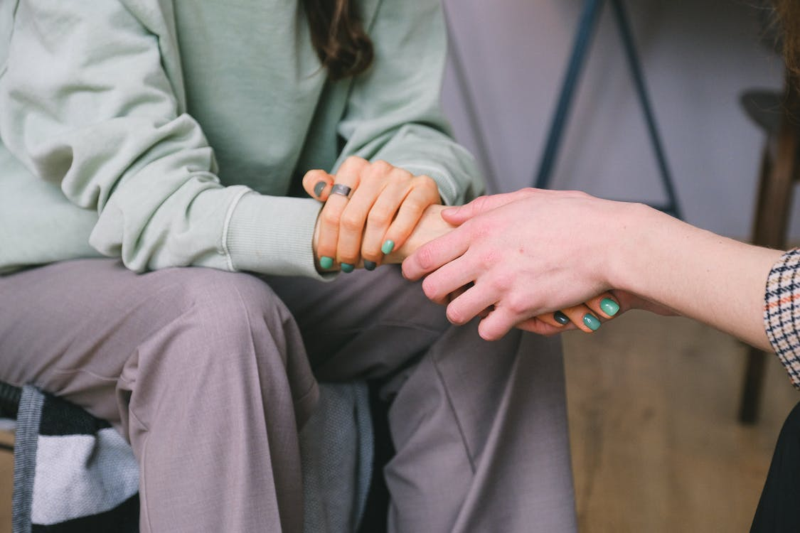 Psychologist holding hands of a patient
